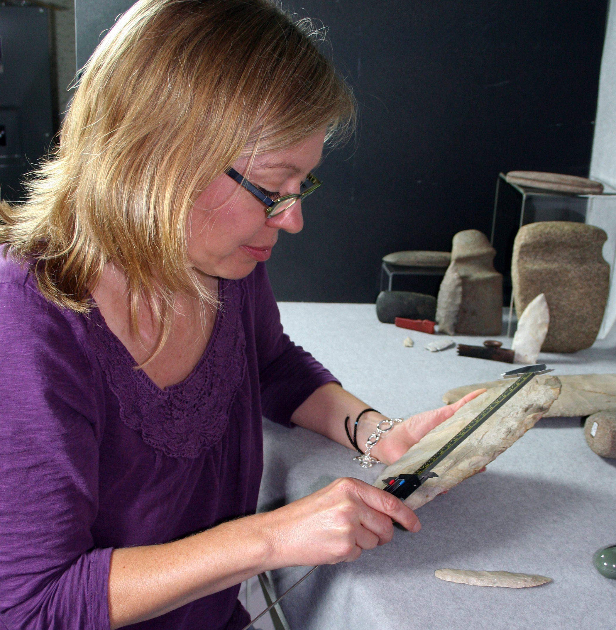 Madeleine Evans measuring a chert hoe Madeleine Evans measuring a chert hoe