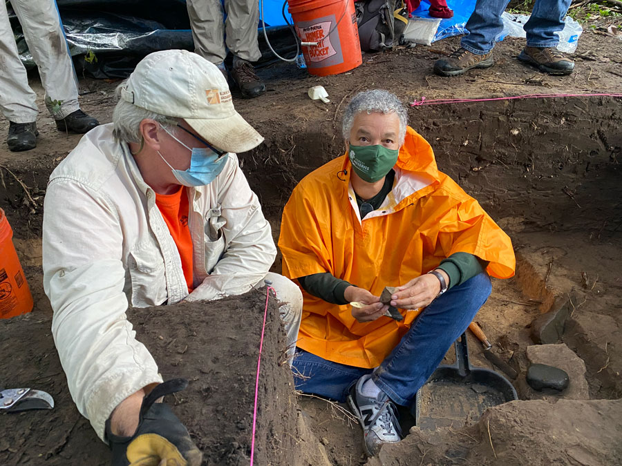 two people who just uncovered an artifact